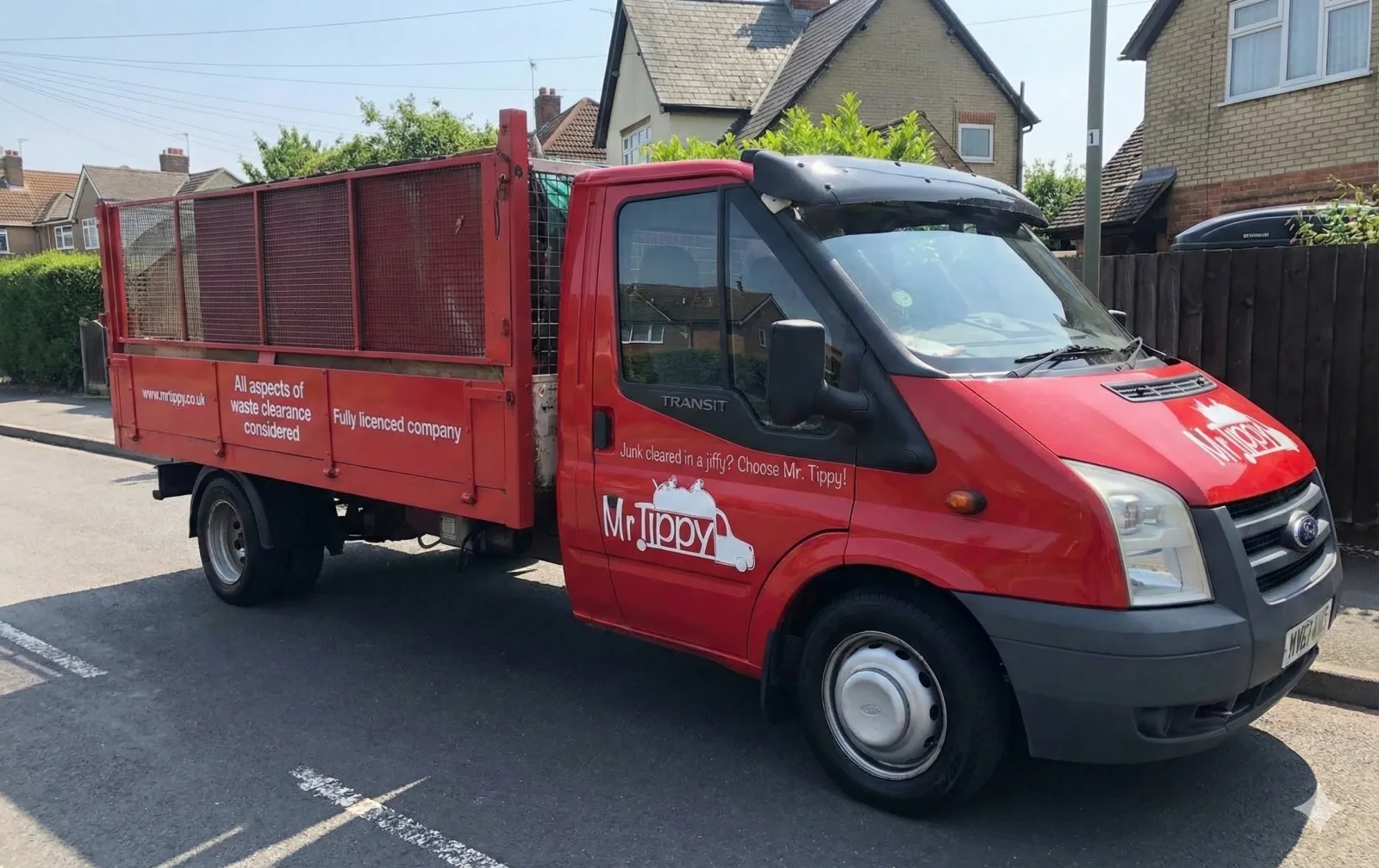 Mr. Tippy's red Ford Transit tipper truck — 'All aspects of waste clearance considered · Fully licenced company'